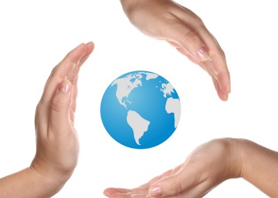 Conceptual safety symbol made from hands over Earth globe